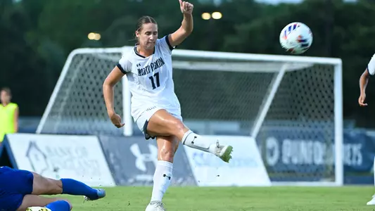 Analiese Anderson kicking the ball against UF
