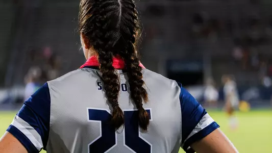 Liz Anne Fogarty standing back to the sidelines