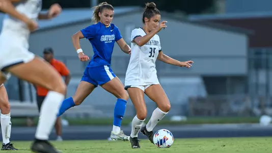 Paige McSwigan dribbling against Florida