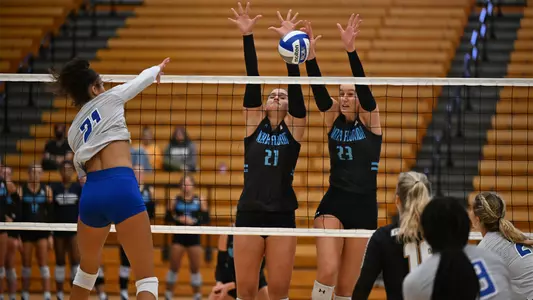 Kyla Solis and Kierstyn McFall going up for a block at the net