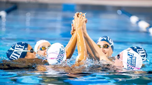 Women's swimming group high five