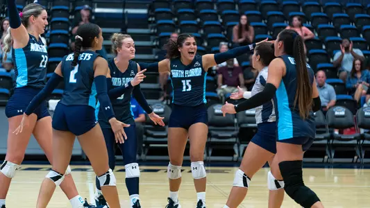 unf volleyball team photo celebrating