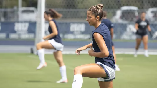 Chloe Lynch warming up on the pitch