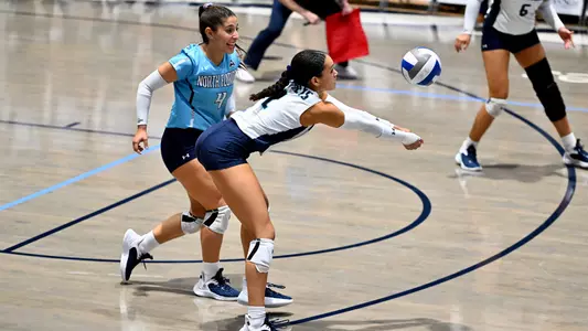 Kailey McKnight digging the ball with Rocio Moro