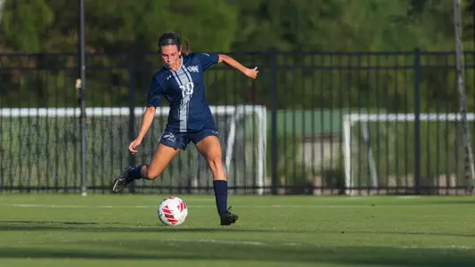 Amanda Hartmann kicking the ball against Mercer