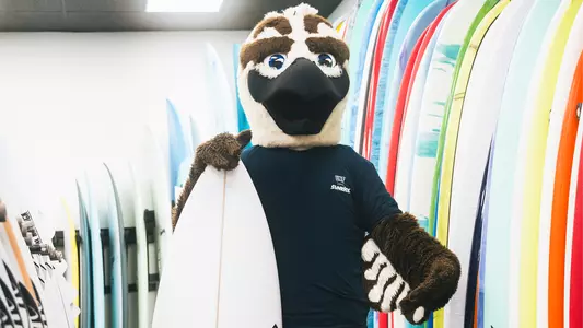Ozzie holding a surfboard