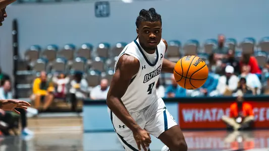 Jaylen Smith dribbling the ball against Edward Waters