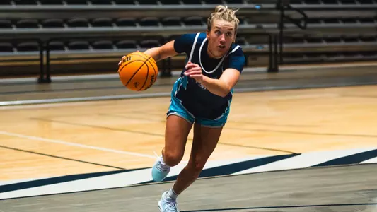 Grace Hunter driving upcourt in practice