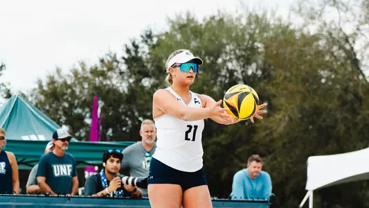 Mackenzie Murphy preparing to serve at The Coop Beach Volleyball Complex