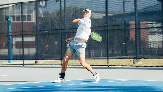 PJ Kotan returning shot in singles play