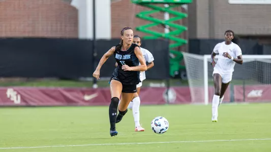Layla Thompson dribbling up the field