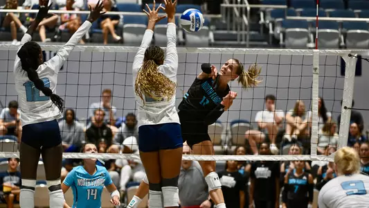 Amy Burkhardt hitting the ball against Rhode Island