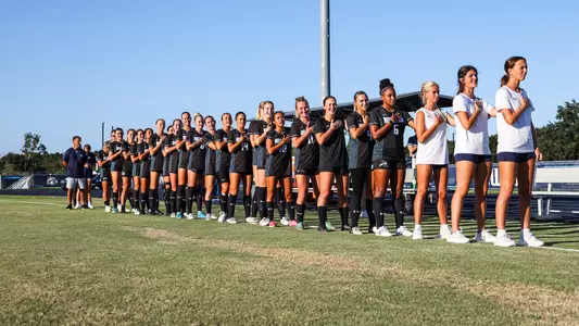 Women's soccer lined up for the national anthem