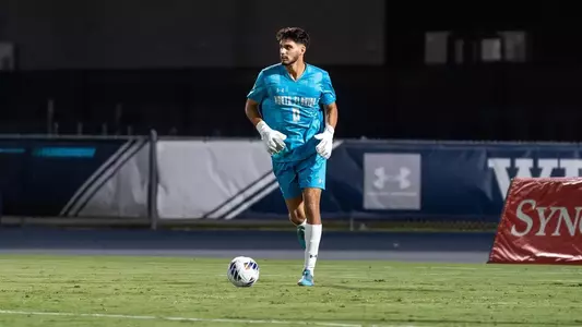 Goalkeeper Iu Pentinat controls the ball at his feet, ready to clear it to a teammate