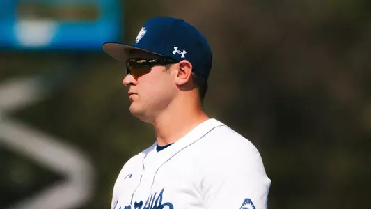 Cade Bush with glasses at first base