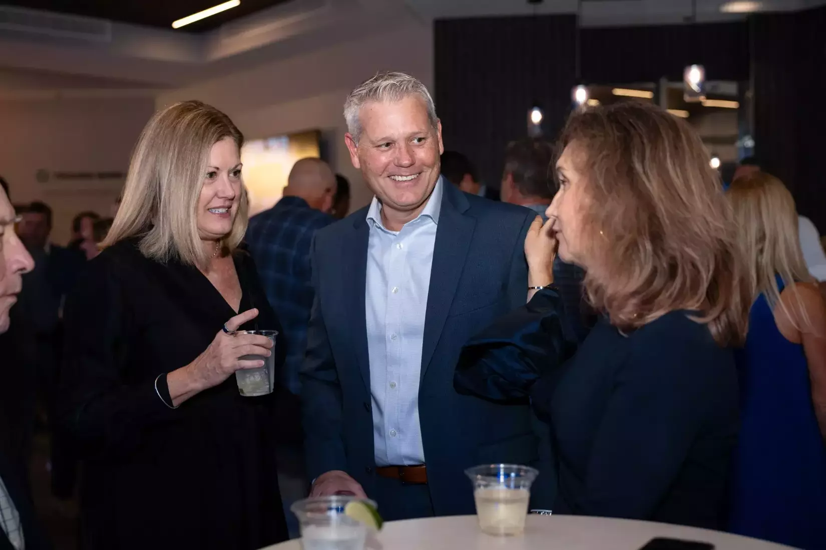 People talking together at blue and gray bash.