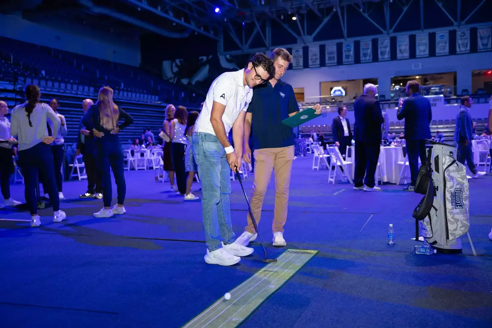 People playing putt putt golf at clue and gray bash.