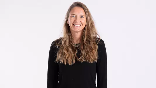 Tara Sunquist smiling on white backdrop