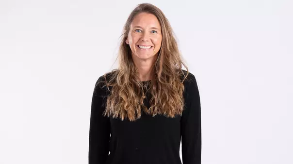 Tara Sunquist smiling on white backdrop
