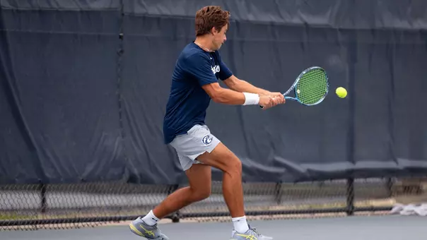 Junior Joao Portugal Hitting A Tennis Ball