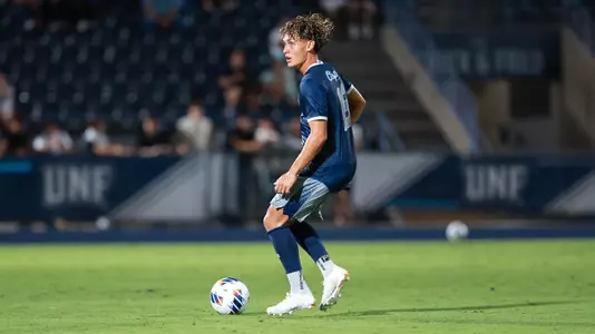 Brian McManus Jr. with ball at his feet looking up the pitch