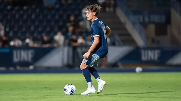 Brian McManus Jr. with ball at his feet looking up the pitch