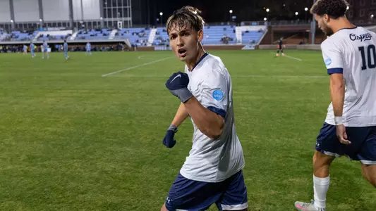 Defender Brian McManus Jr. looks at the camera and celebrates a goal with a fist pump
