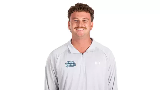 White backdrop photo of Assistant Coach Makai Lipson