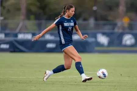 Women's soccer player dribbing ball