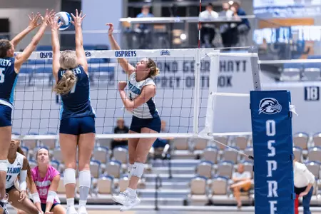 UNF Volleyball player hits ball over net