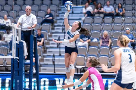 UNF Volleyball player hits ball over net