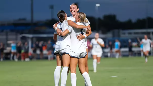 UNF Women's soccer team celebrates a goal.