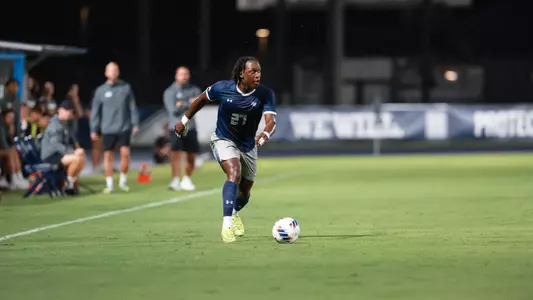 North Florida's Germain Kapela dribbling vs. South Carolina