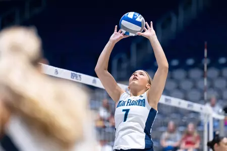 Kacey Kazmierski setting the ball