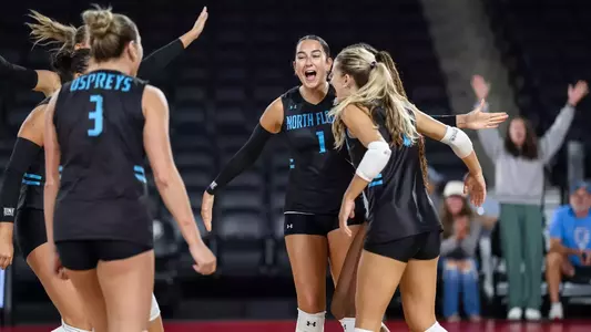 Sofia Dawson celebrates with teammates in group huddle