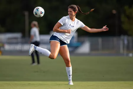 UNF Women's soccer player flicks the ball into the air