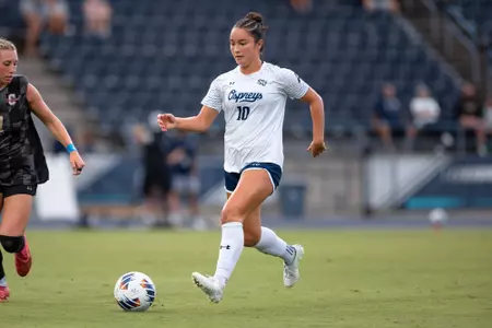UNF Women's soccer player dribbles the ball