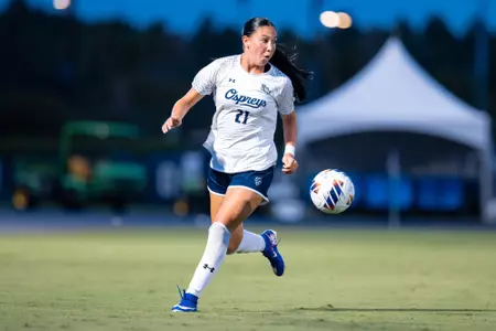 UNF Women's soccer player runs after a bouncing ball