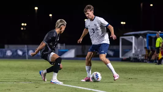 Defender Alfie Mattocks squares up and attempts to a dribble a ball past another player