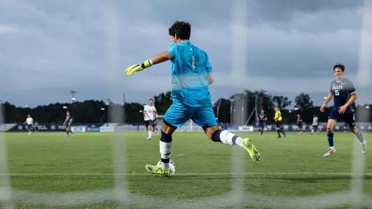 Goalkeeper Luciano Natoli clears the ball from the goal area through the net
