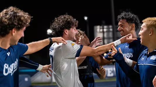 Goalkeeper Akash Poola celebrates with defender Bryce Warhaft and midfielder Rentaro Miyakawa