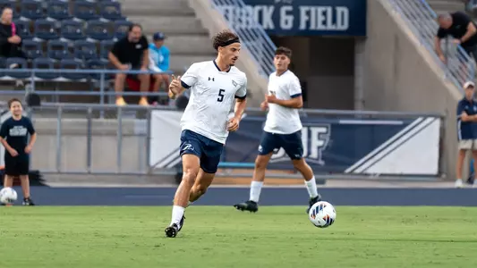 Defender Paul Schacherer dribbles a ball across the field