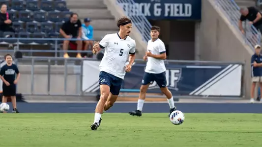 Defender Paul Schacherer dribbles a ball across the pitch