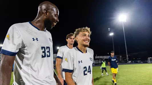Forward Kaiss Mansouri smiles after a match with defender Diogo Garcia