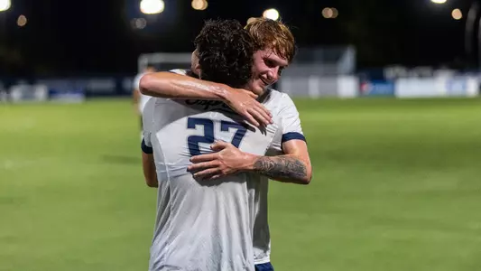 Midfielder Cameron Gray celebrates with defender Bryce Warhaft