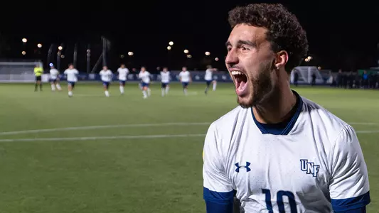 Midfielder Anton Khelil celebrates a successful penalty kick with his teammates in the background