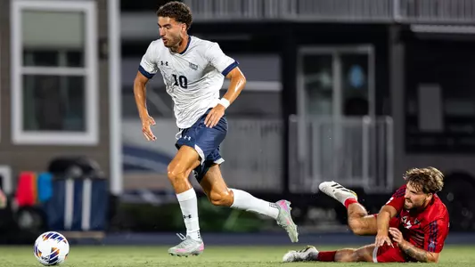 Midfielder Anton Khelil dribbles past an opposing player