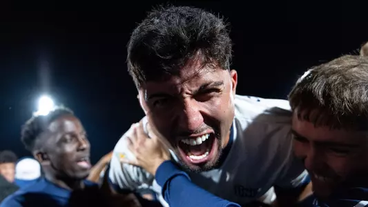 Forward Geraldo Neto lets out a scream at the camera and celebrates with teammates