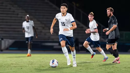Midfielder Omar Trio dribbles the ball at his feet