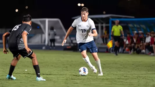 Midfielder Mark Romano dribbles toward an opposing player